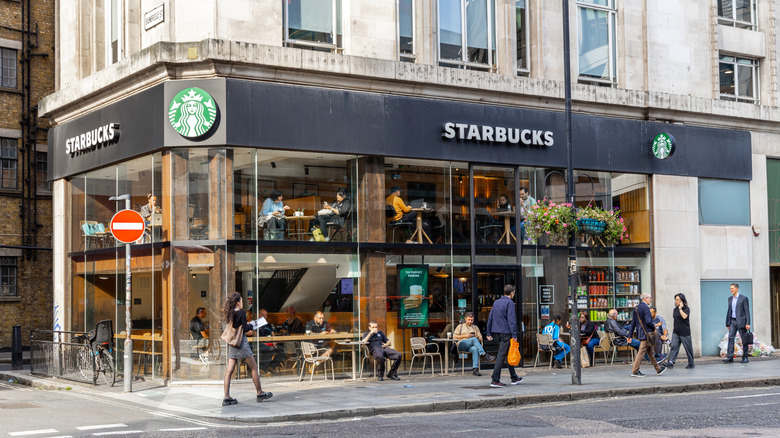 The glass and metal exterior of a Starbucks coffee shop in London.
