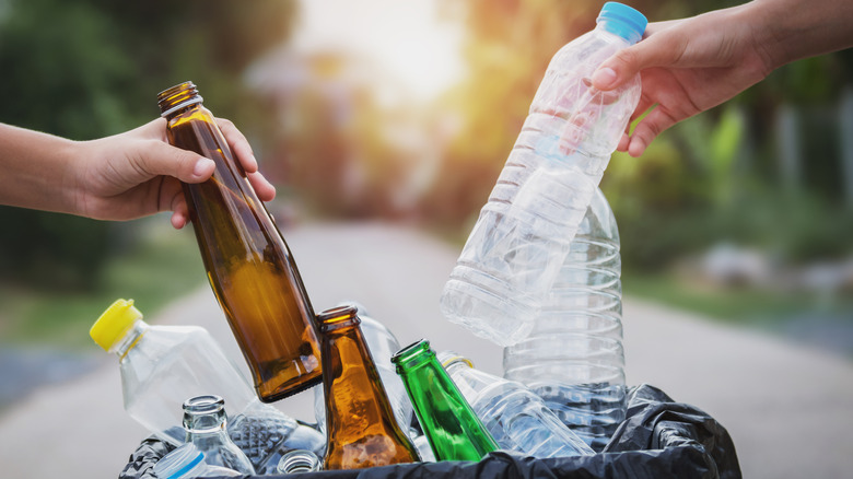 People recycling plastic bottles