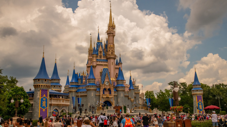 Disney World castle in Florida with blue skies and white puffy clouds.