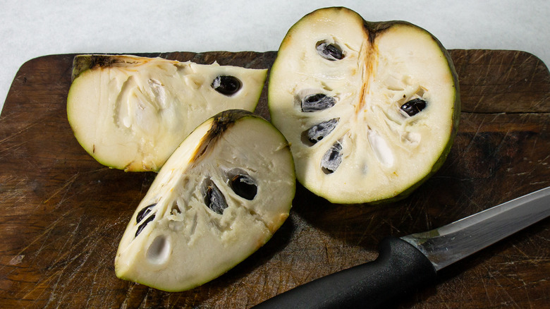 Cherimoya on a brown wood cutting board