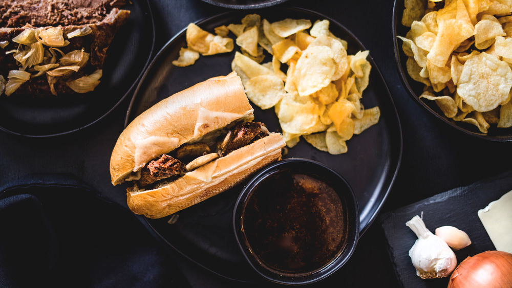 French dip sandwich on a black plate