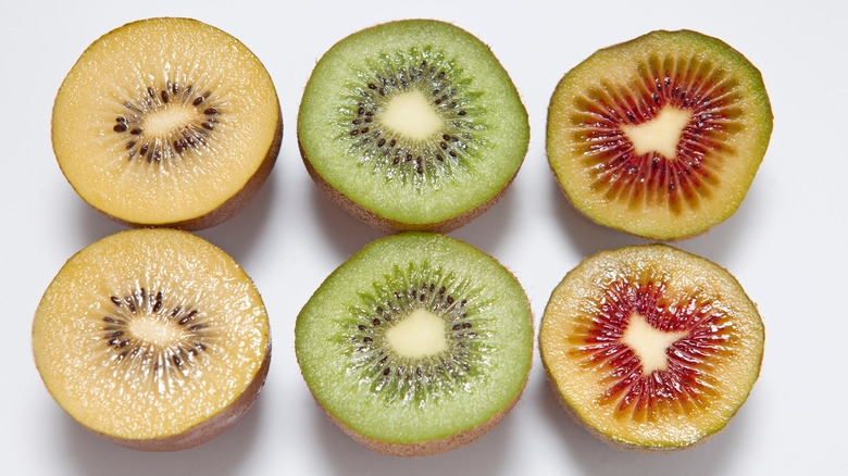 Three different colors of kiwis cut in half