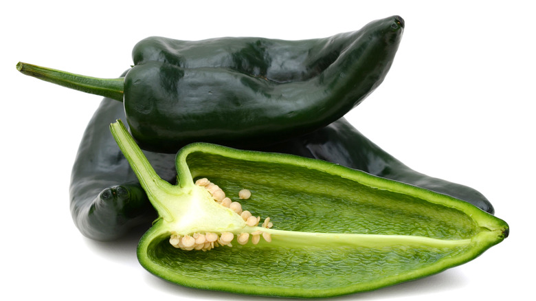 Whole and sliced poblano peppers