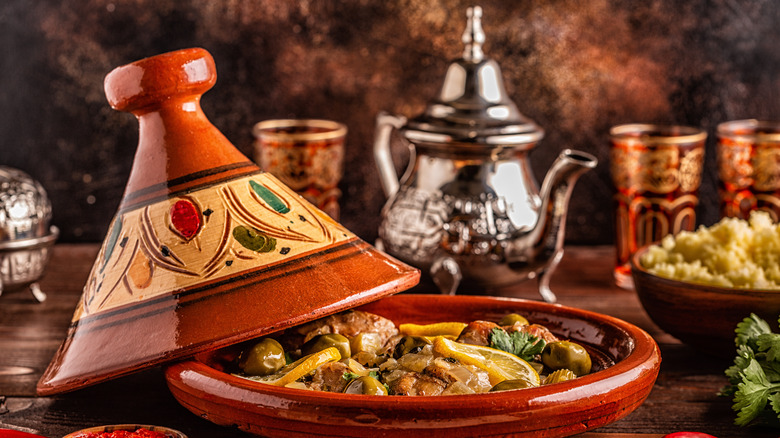 Open tagine next to silver tea pot