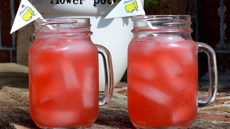 Two pink cocktails with Masters flags garnishing