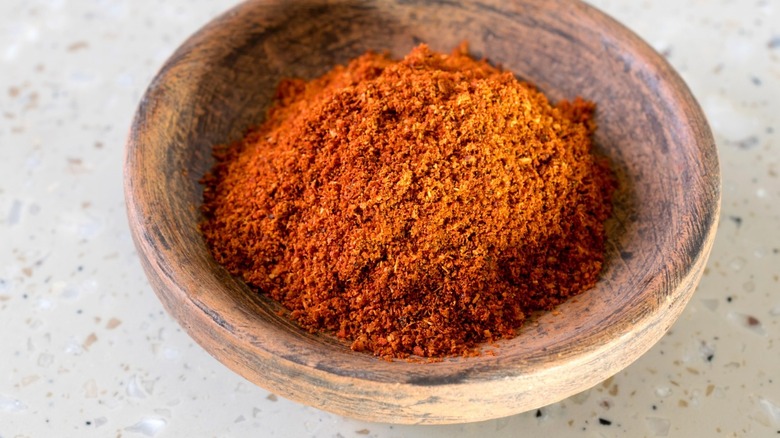 Ground berbere spice in wooden bowl