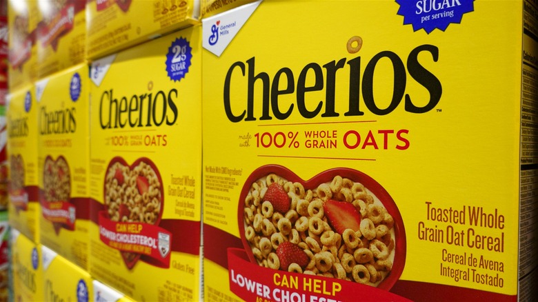 Boxes of original Cheerios displayed on grocery shelves.