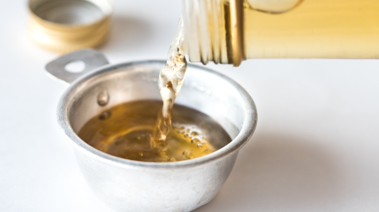 Vinegar being poured into a cup