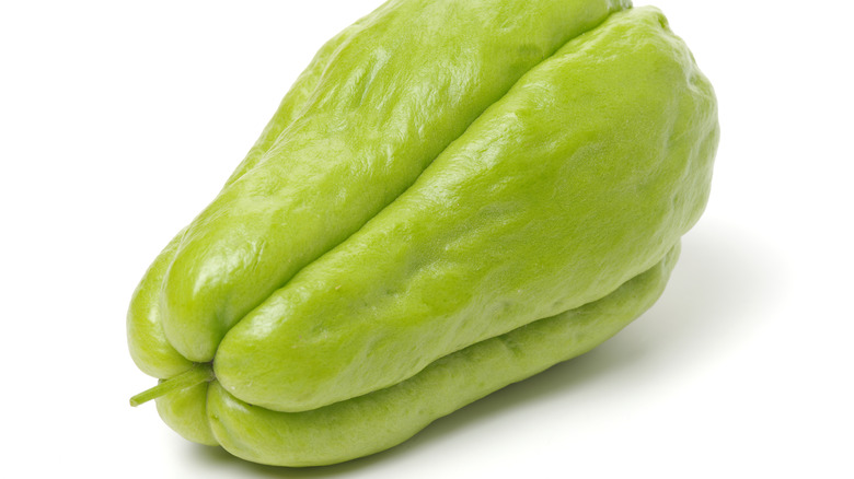 Single chayote squash on white background