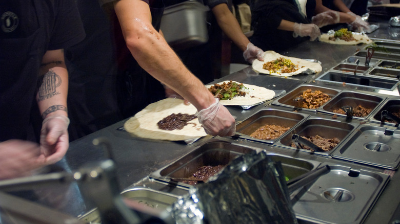 Chipotle employees serving food