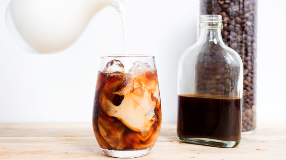 Cold brew with milk pouring in