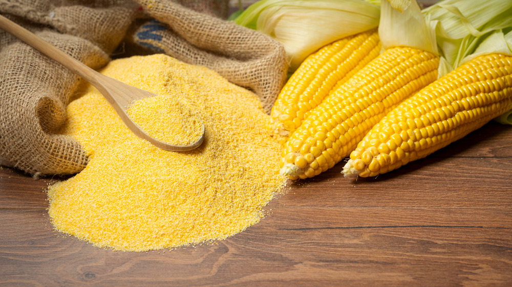 Yellow corn placed next to cornmeal