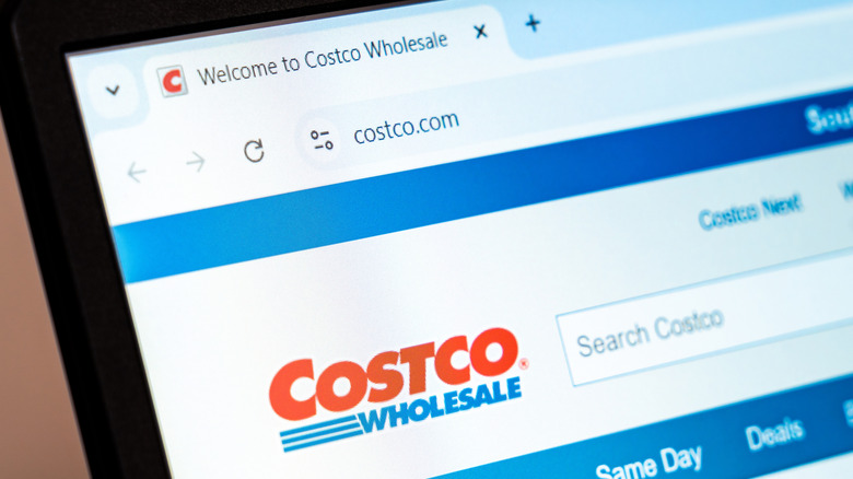 An image of the Costco Wholesale website open on a computer screen with red and blue text