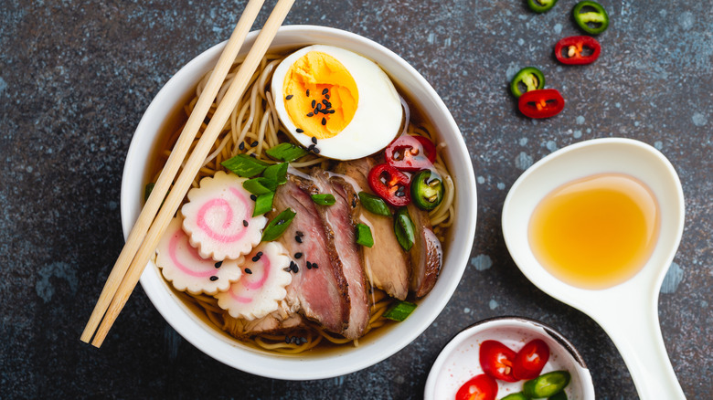 Ramen noodle soup topped with fish cake and hard boiled egg