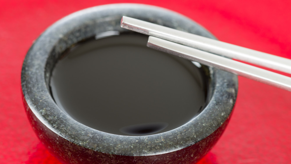 bowl of kecap manis with chopsticks