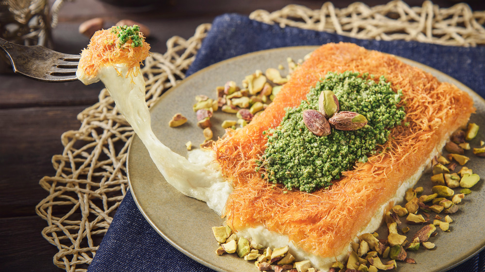 A fork stretching out the insides of a kunafa