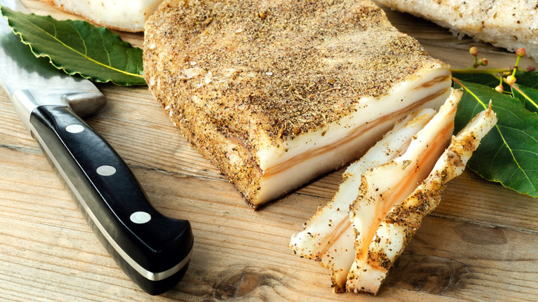 lardo on wood table with knife