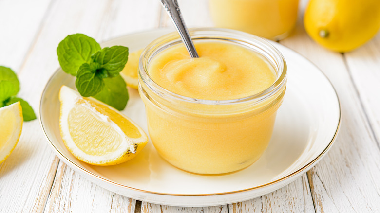 A jar of lemon curd with a spoon