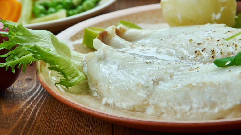 White lutefisk on a brown plate