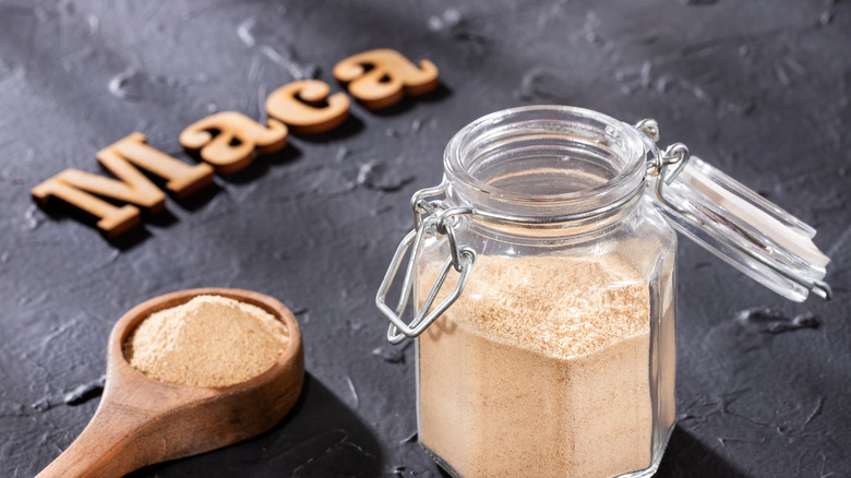 A jar of maca with maca spelled in wooden letters
