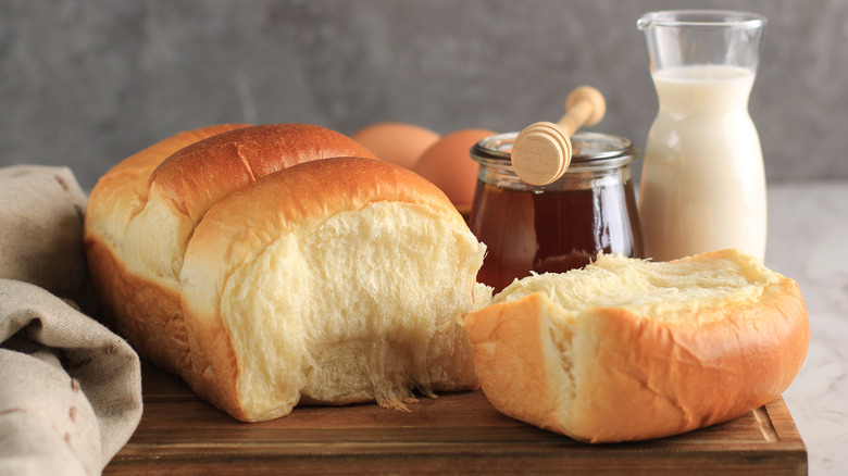 Milk bread on a tray with milk and honey