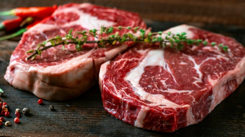 Ribeye steaks topped with fresh herbs