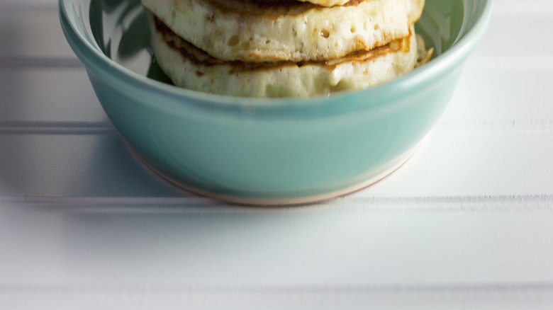 Syrup pouring onto pancakes