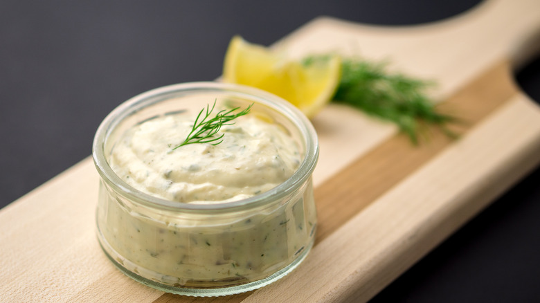 Tartar sauce garnished with dill in glass jar