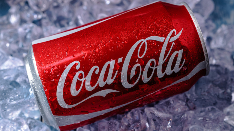A red can of Coca-Cola over ice.