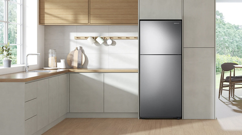 Samsung top freezer refrigerator in white kitchen.
