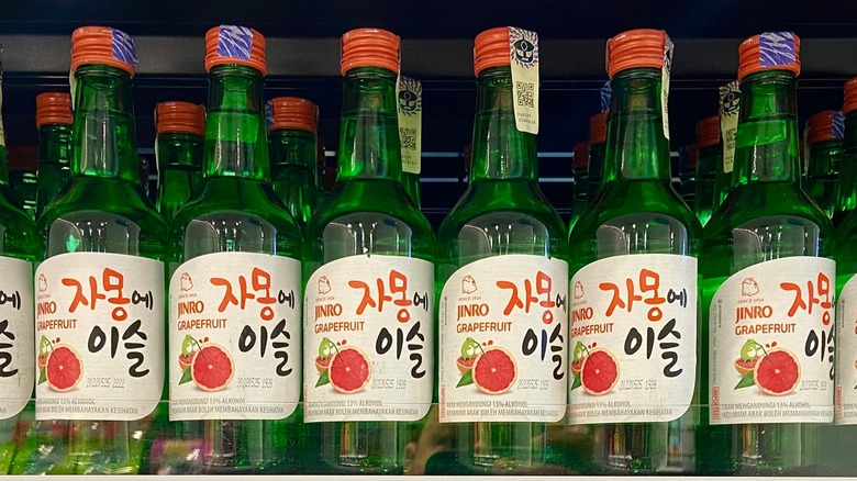 Closeup of Jinro soju bottles on store shelf.