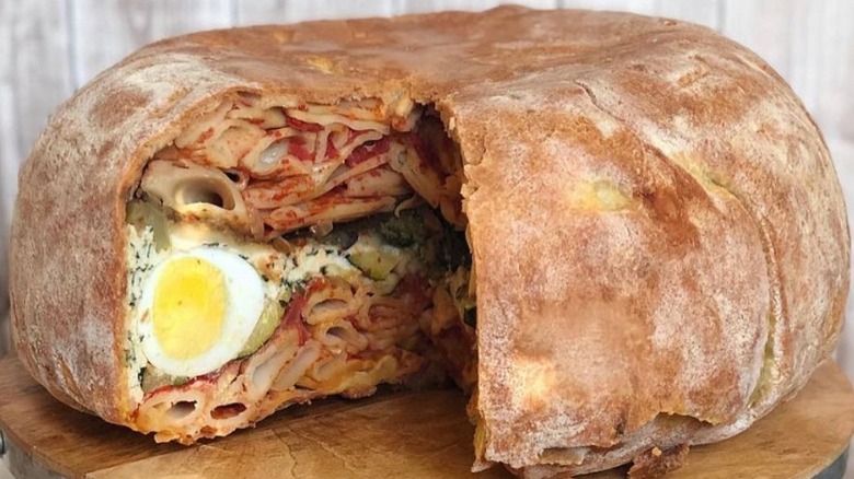 timpano with a crust cut open to show inside