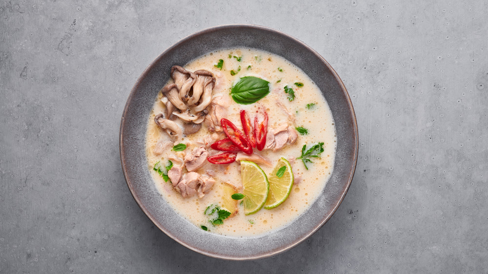 Bowl of tom kha on gray background