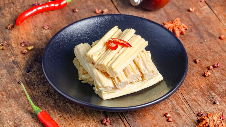 A plate of yuba sticks with red chillies