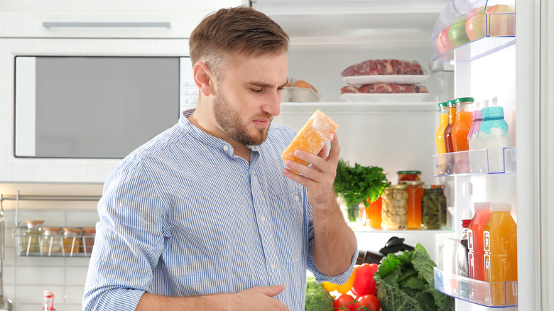 Man reacting to bad cheese smell 