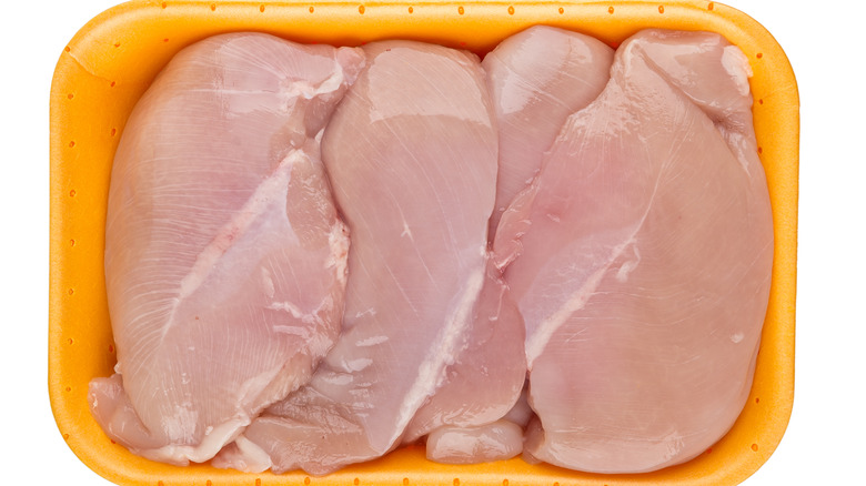 Raw chicken in yellow tray