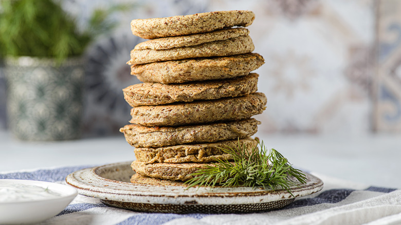 Stack of pancakes made with lentils next to dill sprig