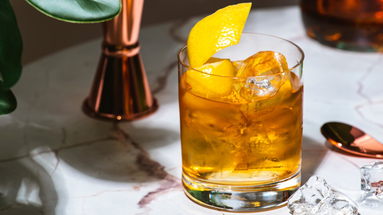 Aged tequila on the rocks with a lemon twist