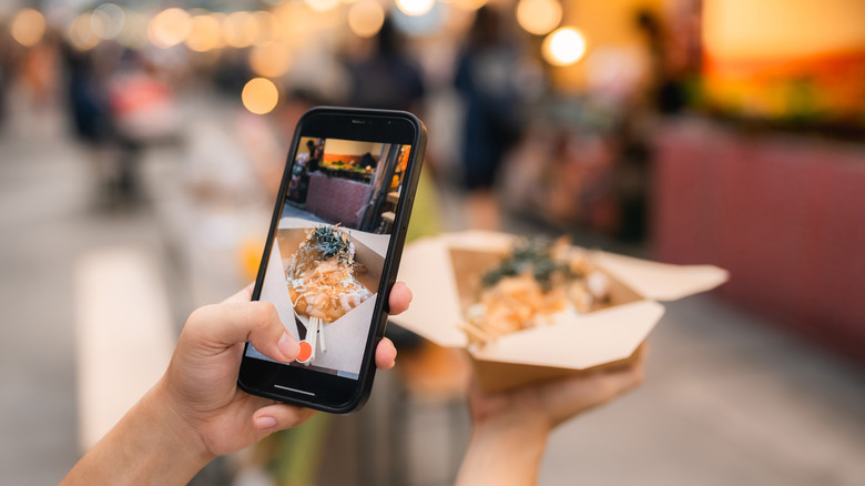 Food influencer taking photo of food