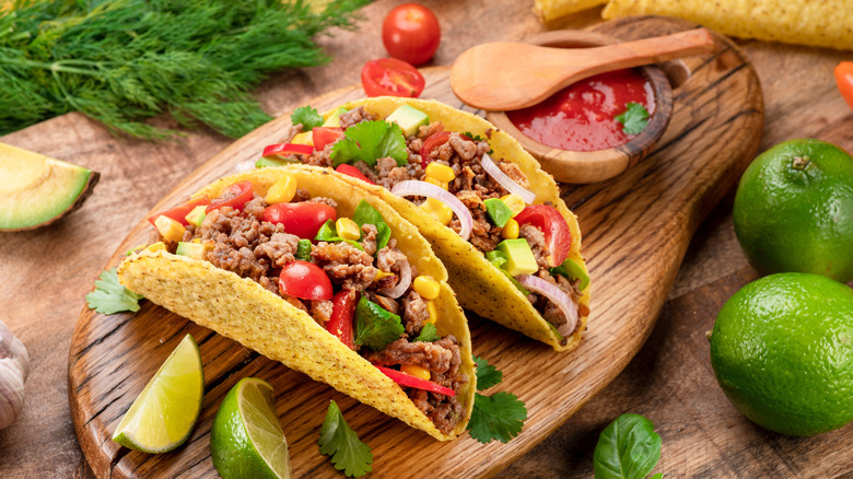 tacos on a wooden serving block
