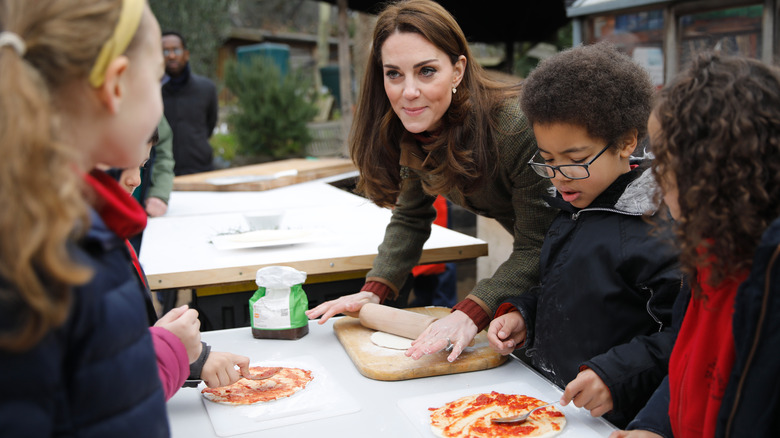 Kate making pizza with kids