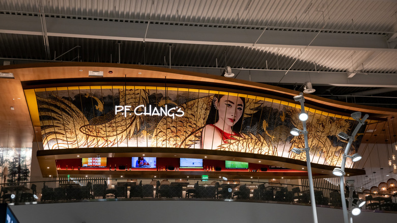 A large P.F. Chang's sign inside an airport food court