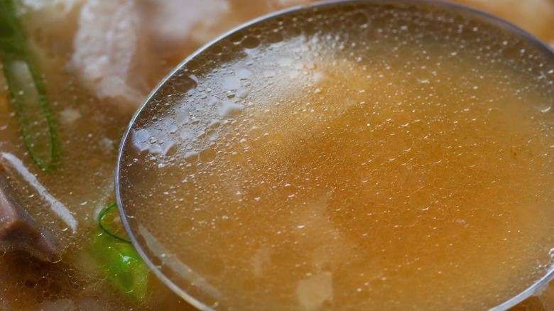 Simmering soup on ladle