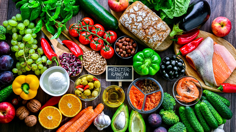 Staged photo of variety of foods included in the Meriterranean Diet, including fish, fruits, vegetables, and legumes