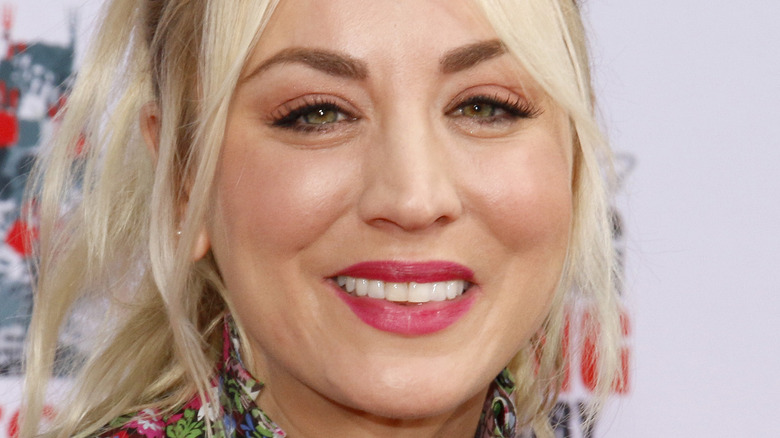 Kaley Cuoco smiles with pink lipstick