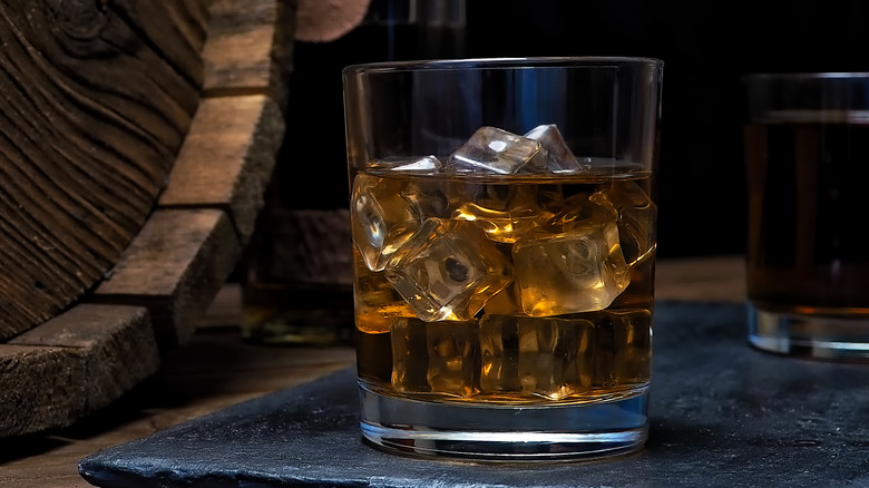 Whiskey glass next to barrel
