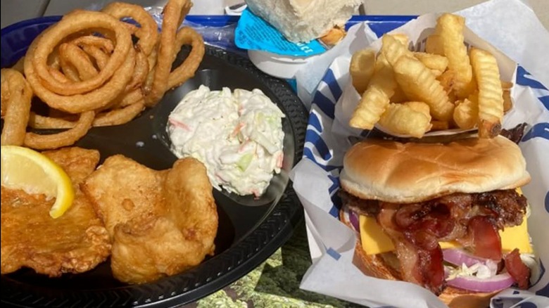 ButterBurger and fish with assorted side dishes, including onion rings, coleslaw, and fries at Culver's.