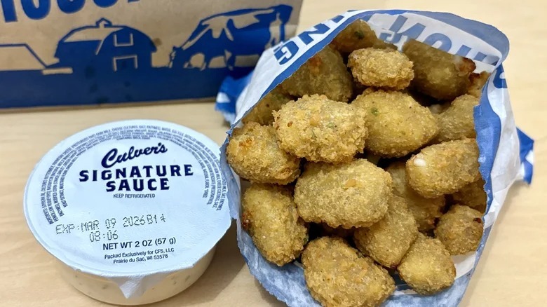 Culver's jalapeño cheese curds in bag next to package of culver's signature sauce
