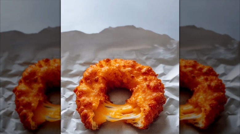 Fried cheese curd in the shape of a donut with cheese pull