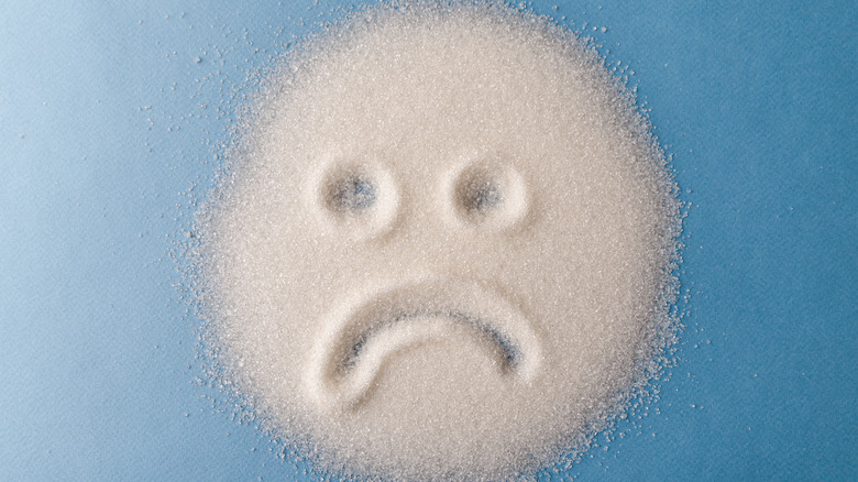 Sad face drawn in sugar